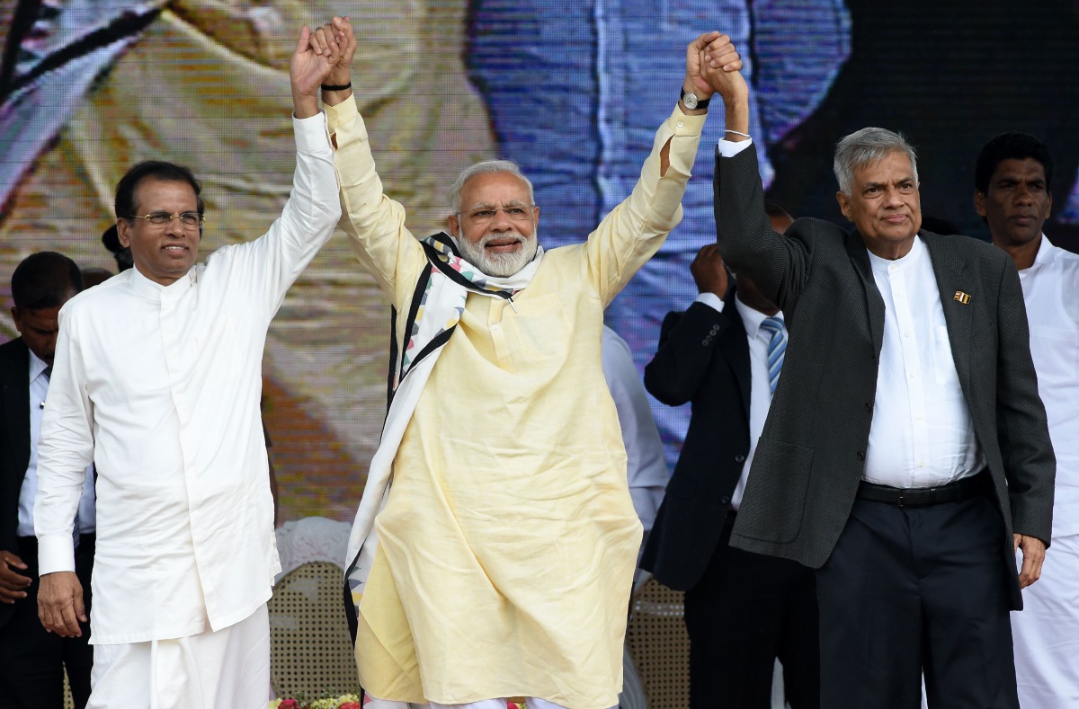 FILE PHOTO: Indian PM Narendra Modi joins hands with Maithripala Sirisena and PM Ranil Wickremesinghe after addressing a public rally in Norwood. AFP/Ishara S KODIKARA