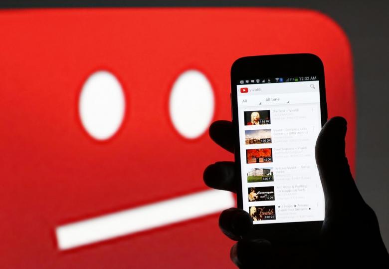 A picture illustration shows YouTube on a cell phone in front of a YouTube copyright message regarding a video on an LCD screen in central Bosnian town of Zenica, June 18, 2014. Reuters/Dado Ruvic