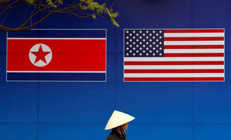File photo of a person walking past a banner showing North Korean and US flags ahead of the North Korea-US summit in Hanoi, Vietnam, February 25, 2019. REUTERS/Kim Kyung-Hoon