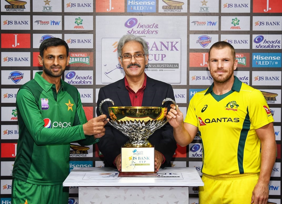 Pakiatani skipper Shoaib Malik (left) and Australaian captain Aaron Finch pose for a photograph yesterday with the JS Bank Cup which will be awarded to the winner of the five-match ODI series, starting in Sharjah today.