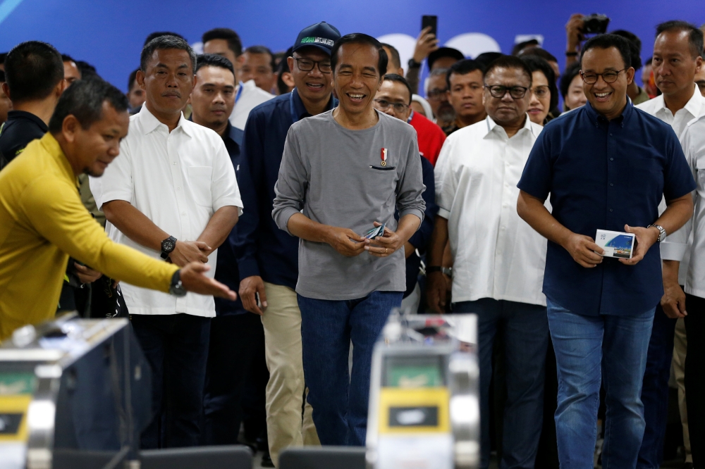 Indonesia's President Joko Widodo (C) walks as he takes part on Jakarta Mass Rapid Transit (MRT) first-phase launching at Istora station in Jakarta, Indonesia, March 24, 2019. REUTERS/Willy Kurniawan