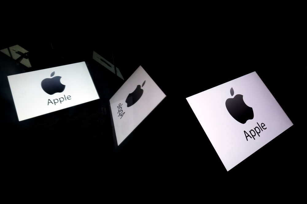 In this file photo taken on February 16, 2019 this illustration picture shows the US multinational technology company Apple logo displayed on a tablet in Paris. AFP / Lionel Bonaventure 