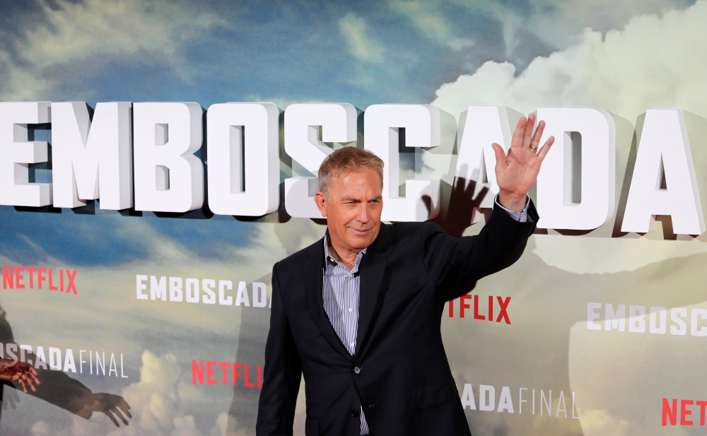 Actor Kevin Costner waves during a photocall to promote his latest film 