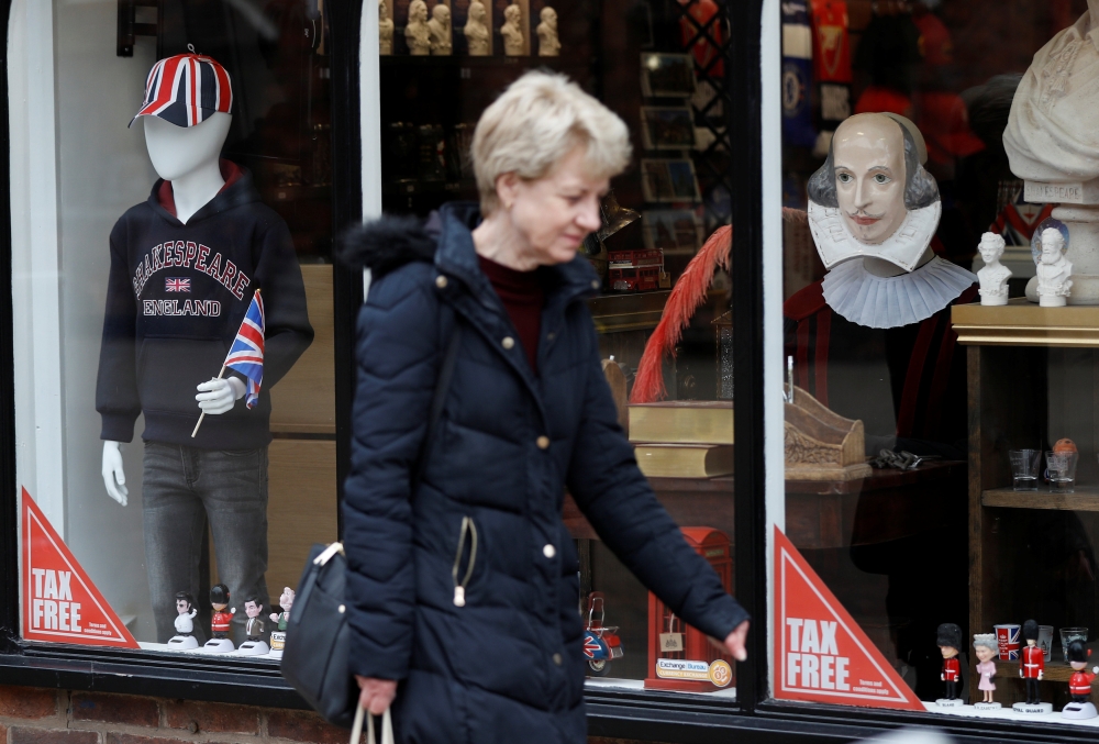 A woman walks past a tourist shop in the centre of Stratford-upon-Avon, Britain, March 22, 2019. REUTERS/Peter Nicholls