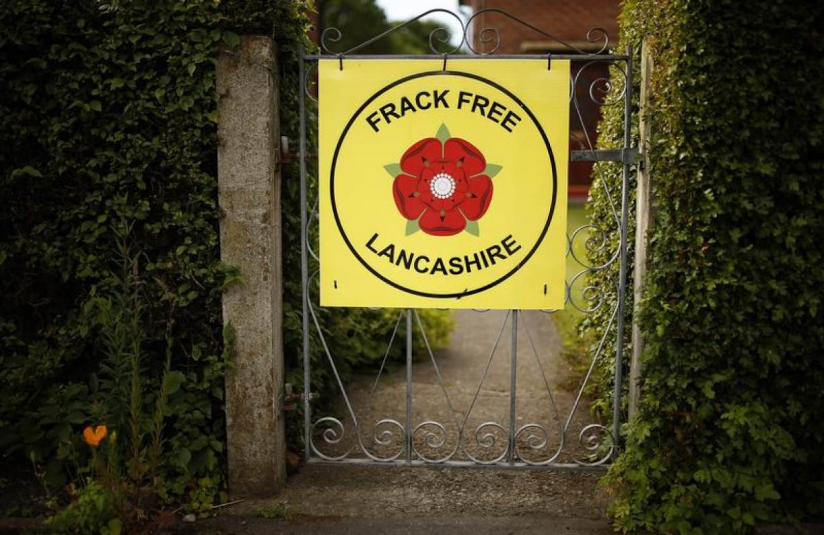 FILE PHOTO: An anti-fracking sign is seen on the gate of a cottage in the village of Little Plumpton, Lancashire, Britain June 23, 2015. Reuters/Phil Noble 
