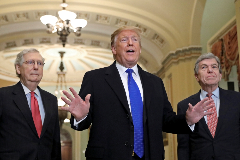 U.S. President Donald Trump talks with reporters next to Senate Majority Leader Mitch McConnell (R-KY) and Senator Roy Blunt (R-MO) as he arrives for a closed Senate Republican policy lunch on Capitol Hill in Washington, U.S., March 26, 2019. REUTERS/Bren
