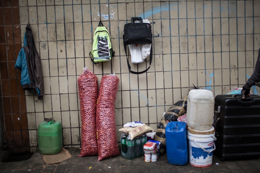 Groceries and other goods stand ready on the side of the road in central Johannesburg to be transported across the border to Zimbabwe by oMalayitsha on February 20, 2019. AFP / Gulshan Khan 