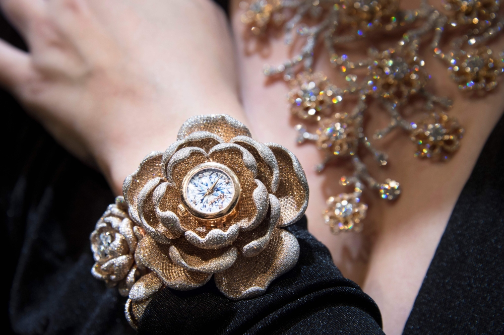 Kerstin Cook, Miss Switzerland 2010, poses with the watch with the most diamonds set on it at the Baselworld watch and jewellery fair on March 22, 2019, in Basel. The watch created by Aarum Shum Jewelery has 15, 858 dimoands set on it. AFP / Sebastien Boz