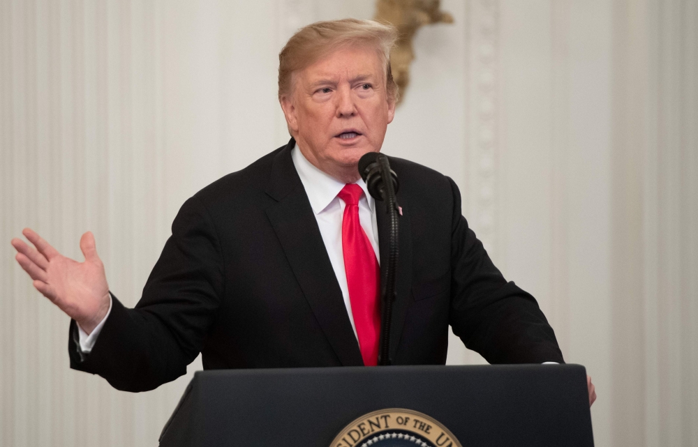 US President Donald Trump speaks prior to awarding a posthumous Medal of Honor for US Army Staff Sergeant Travis Atkins during a ceremony in the East Room of the White House in Washington, DC, March 27, 2019.  AFP / SAUL LOEB