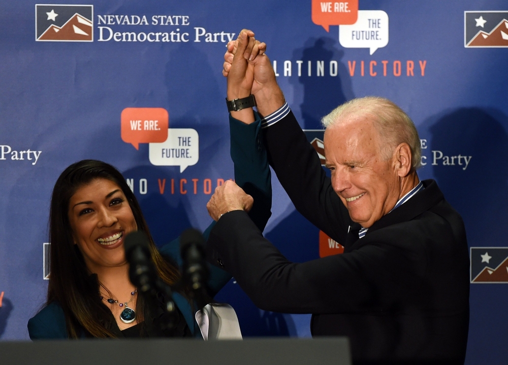 In this file photo taken on November 1, 2014 former Democratic candidate for lieutenant governor and current Nevada Assemblywoman Lucy Flores (D-Las Vegas) (L) introduces former US Vice President Joe Biden at a get-out-the-vote rally at a union hall in La