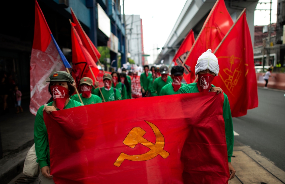 Members of the Philippine communist movement hold a lightning protest in Manila on March 25, 2019. The group called for the resumption of peace talks with the government. AFP / Noel Celis 