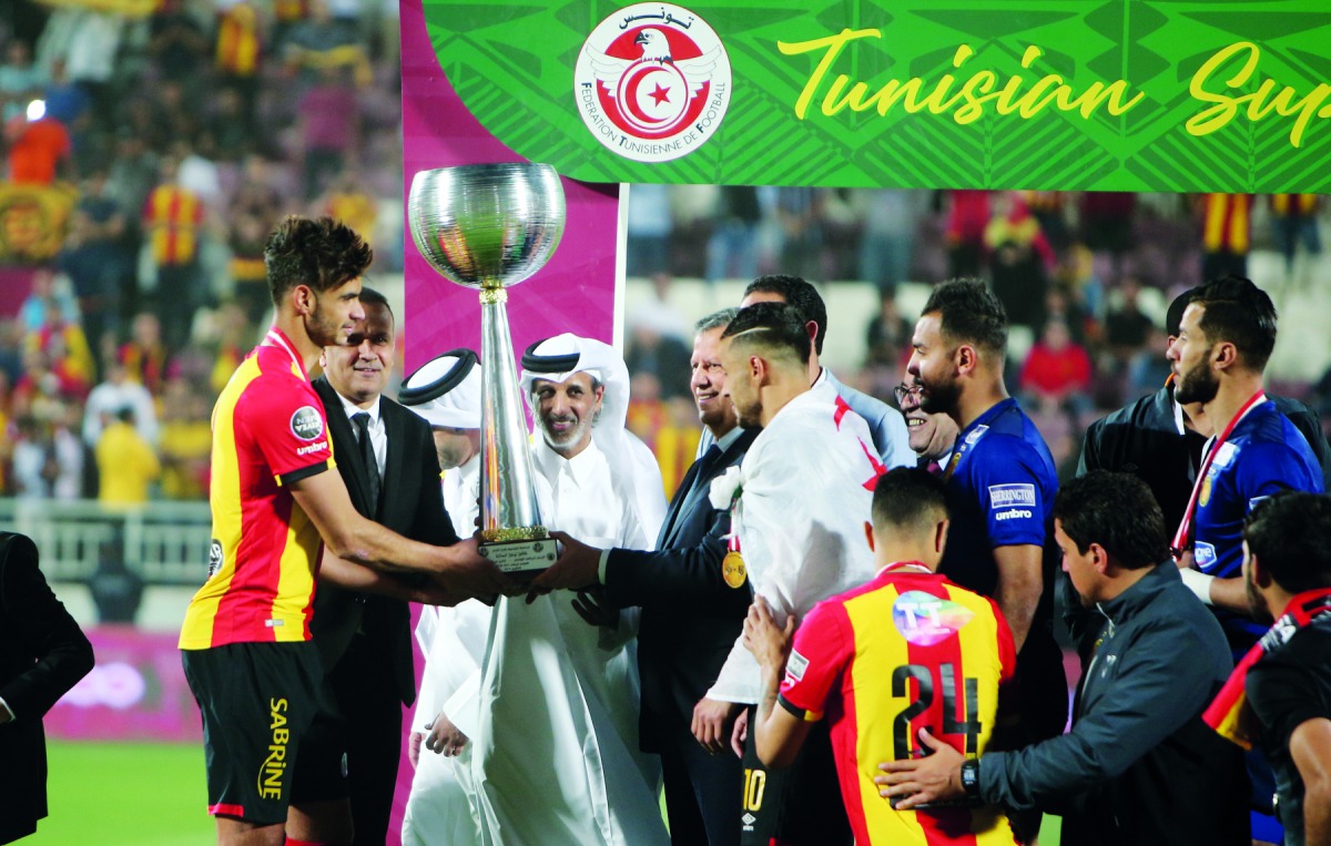 The President of Qatar Football Association, Sheikh Hamad bin Khalifa bin Ahmed Al Thani giving away the trophy to captain of Esperance Sportive de Tunis, winner of the Tunisian Super Cup played at the Abdullah bin Khalifa Stadium yesterday. 