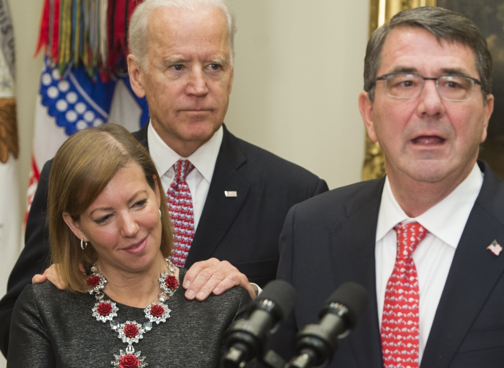 In this file photo taken on February 17, 2015, Secretary of Defense Ashton Carter (R) speaks beside his wife Stephanie and US Vice President Joe Biden during a swearing-in ceremony in the Roosevelt Room of the White House in Washington, DC.  AFP / Saul Lo