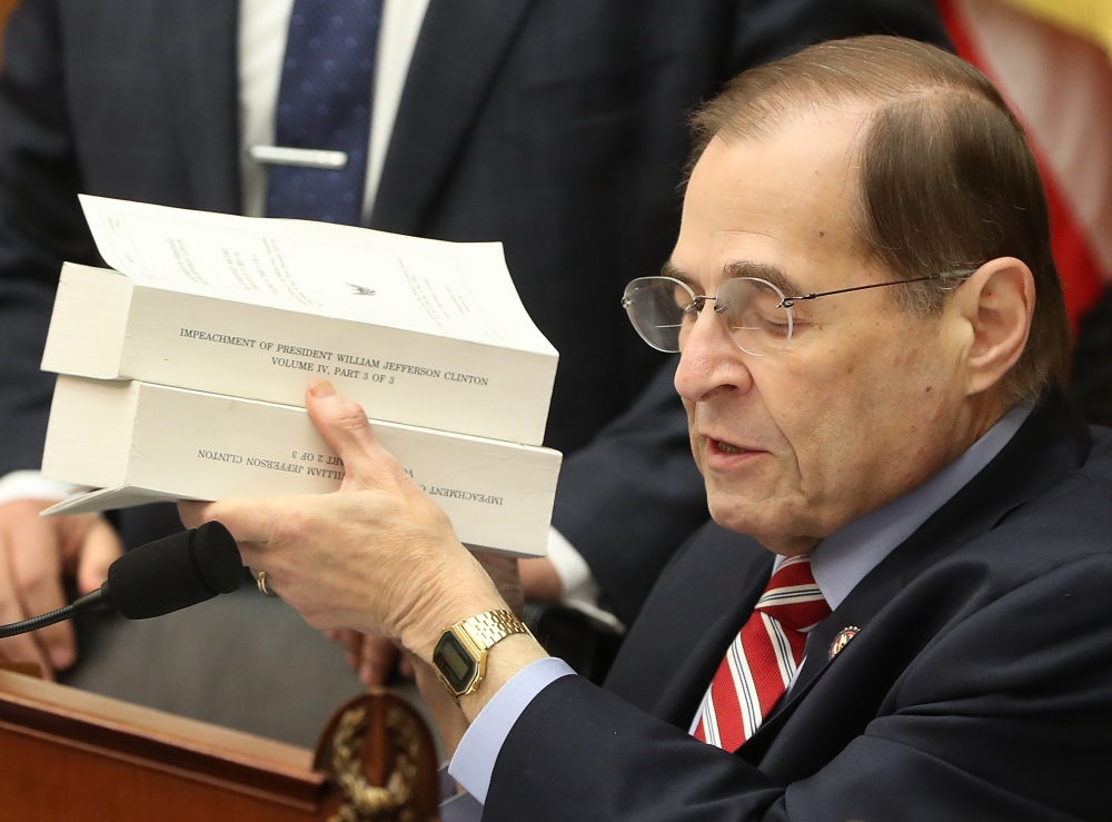 House Judiciary Chairman Rep. Jerrold Nadler (D-NY) holds up copies of the Starr Report during a House Judiciary Committee markup vote on a resolution to issue a subpoena to the Justice Department to receive the full unredacted Mueller report, on Capitol 