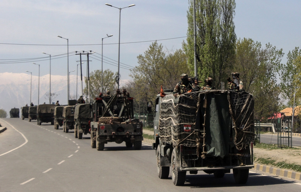 Indian security forces are transported in a convoy on a closed highway on the outskirts of Srinagar on April 7, 2019.   AFP / HABIB NAQASH