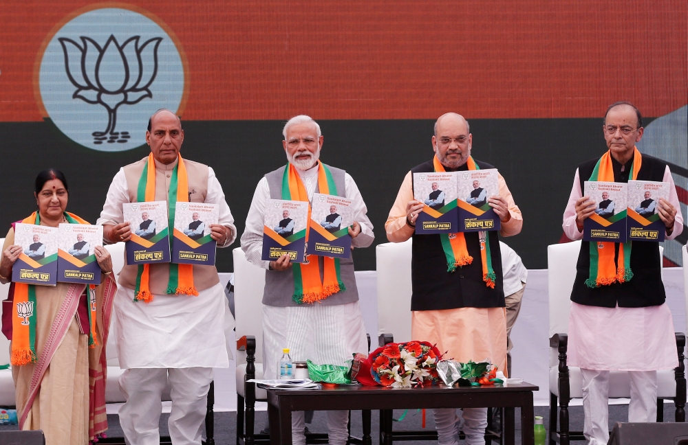 Indian Prime Minister Narendra Modi (C), chief of India's ruling Bharatiya Janata Party (BJP) Amit Shah (2-R), India's Home Minister Rajnath Singh (2-L) India's Foreign Minister Sushma Swaraj (L) and India's Finance Minister Arun Jaitley display copies of