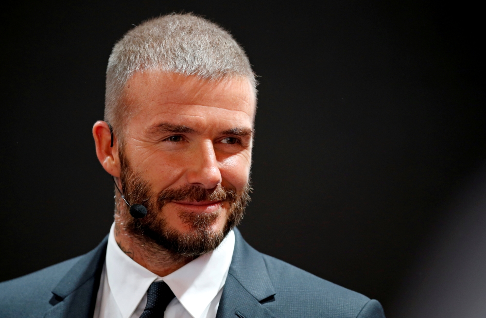 Former football player David Beckham visits the VinFast stand during the first press day of the Paris auto show in France, October 2, 2018. Reuters/Regis Duvignau