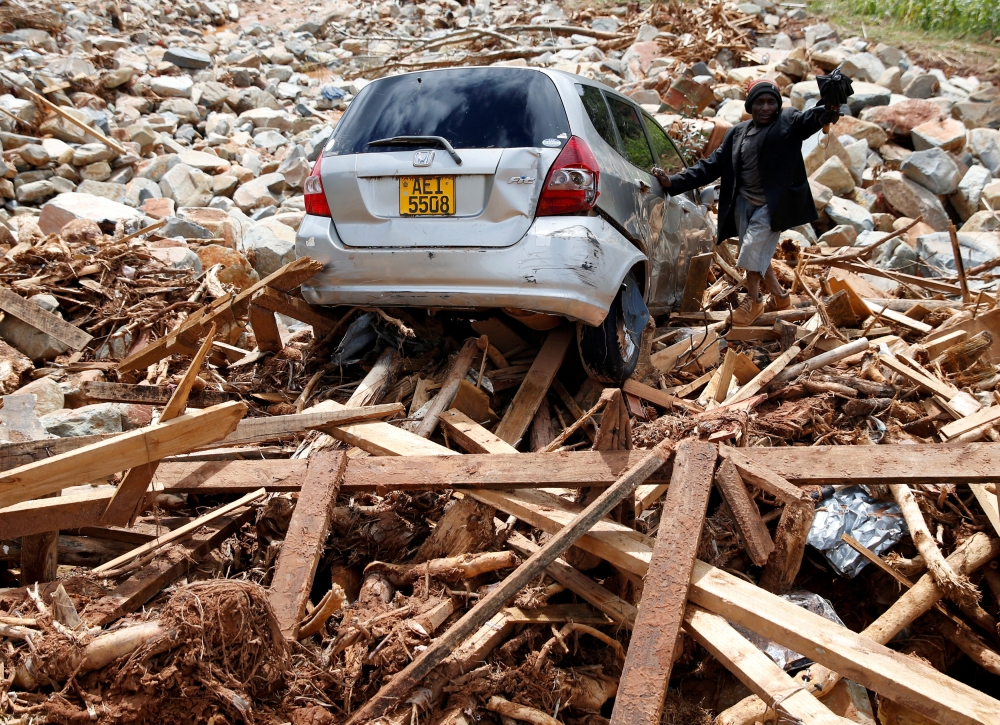 FILE PHOTO: A man gestures next to his car after it was swept into debris left by Cyclone Idai in Chimanimani, Zimbabwe, March 23, 2019. REUTERS/Philimon Bulawayo