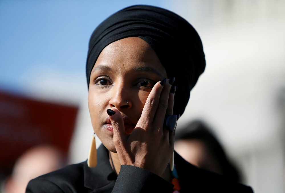 Rep. Ilhan Omar (D-MN) wipes tears from her eye as she speaks about Trump administration policies towards Muslim immigrants at a news conference by members of the U.S. Congress 