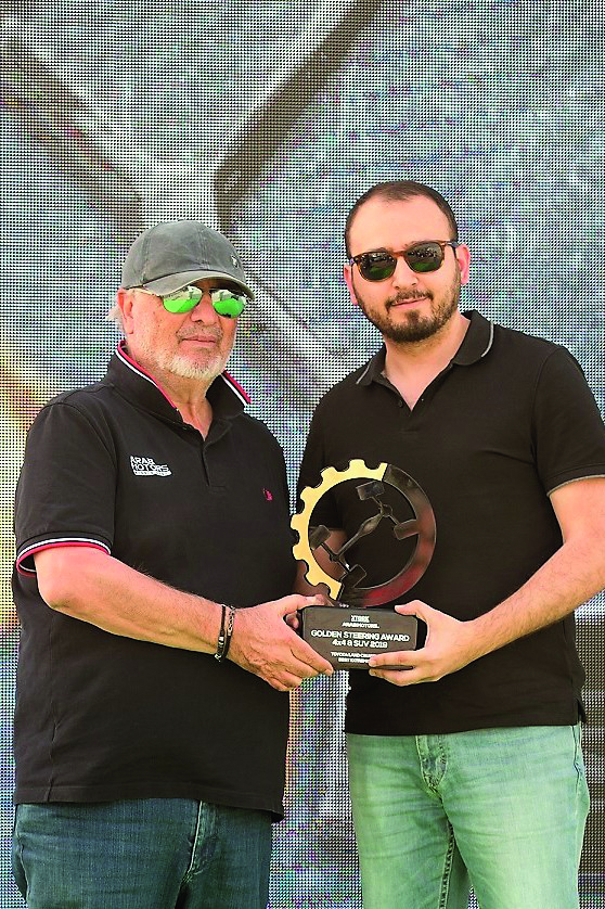 The officials posing with the shield award. 