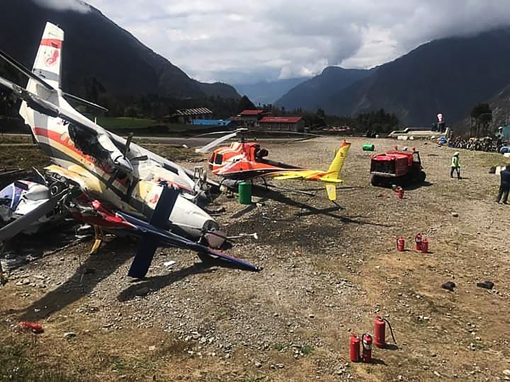 A Summit Air Let L-410 Turbolet aircraft bound for Kathmandu is seen after it hit two helicopters during takeoff at Lukla airport, the main gateway to the Everest region. AFP / STR