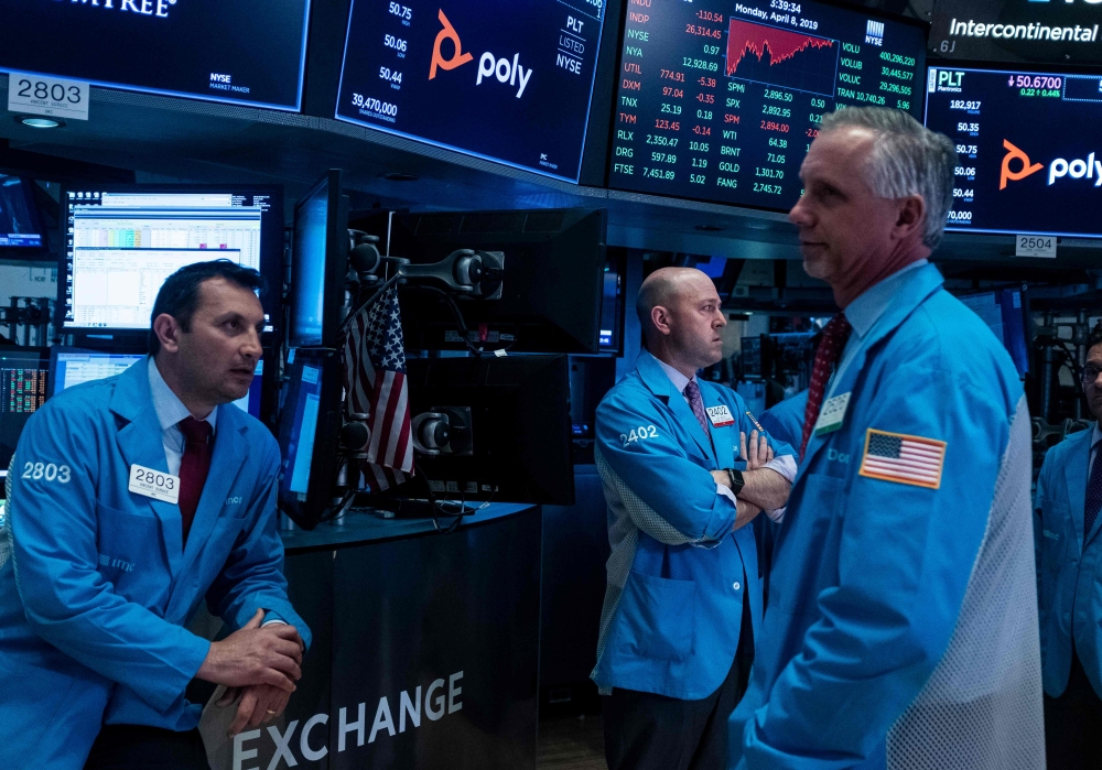 (FILES) In this file photo taken on April 09, 2019 traders work ahead of the closing bell on the floor of the New York Stock Exchange (NYSE) in New York City. AFP / Johannes Eisele 