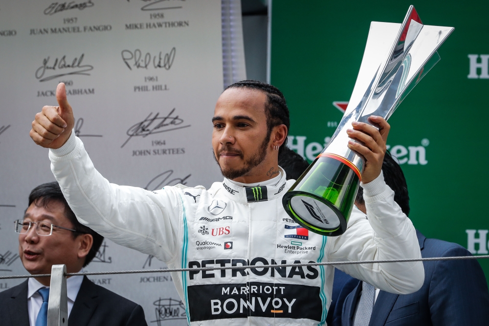 British driver Lewis Hamilton of Mercedes GP celebrates on the podium after placing first in the F1 Grand Prix of China at Shanghai International Circuit on April 14, 2019 in Shanghai, China. ( Stringer - Anadolu 