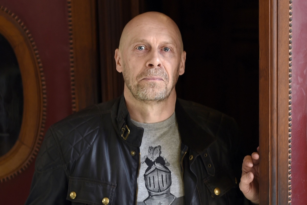 In this file photo taken on March 12, 2015 French far-right writer Alain Soral poses holding disc as he arrives at the Paris courthouse in Paris on March 12, 2015.  AFP / Loic Venance
 
