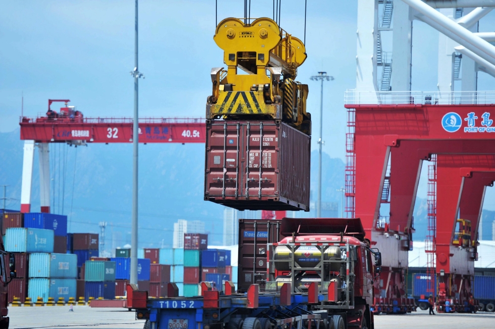 A container is transferred at a port in Qingdao, Shandong province in eastern China on July 6, 2018. AFP