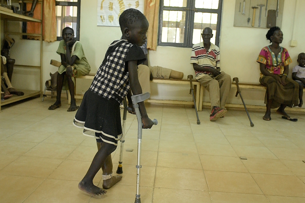 Laytol, 5, walks with the use of a new prosthetic limb at the physical rehabilitation centre run by the International Committee of the Red Cross (ICRC) in Juba on March 12, 2019. AFP/Simon Maina 