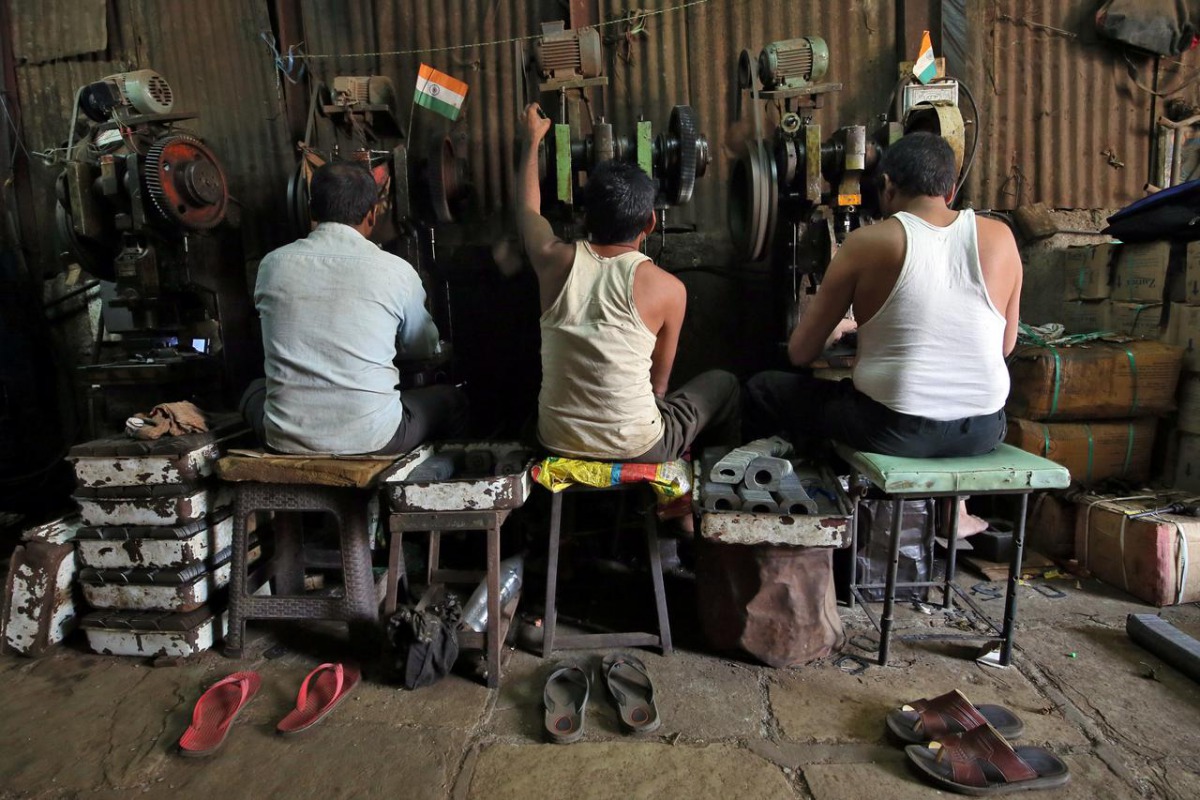 FILE PHOTO: Workers operate metal cutting machines inside a workshop at an industrial area in Mumbai, India, November 30, 2018. REUTERS/Francis Mascarenhas