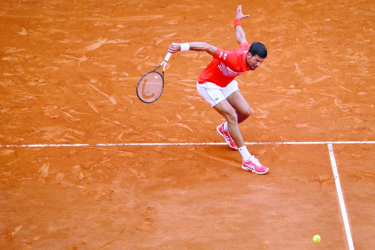 Serbia's Novak Djokovic plays a backhand return to Germany's Philipp Kohlschreiber during their tennis match on the day 4 of the Monte-Carlo ATP Masters Series tournament on April 16, 2019 in Monaco.  AFP/Valery Hache
