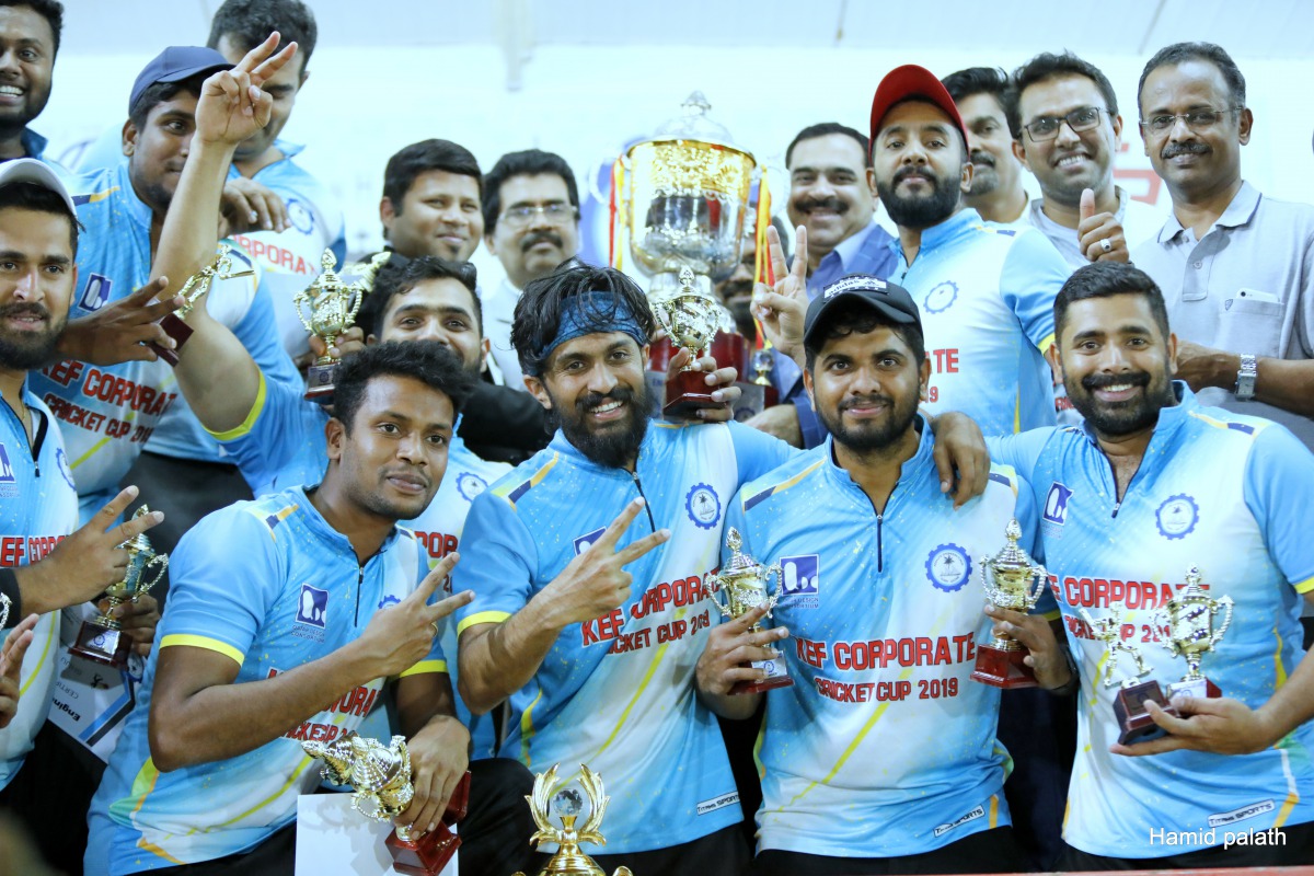 Players and officials of Qatar Design Consortium celebrate with the KEF Engineers Corporate Cup 2019 after defeating Galfar Al Misnad in the final played at the Ideal Oval in Al Hilal, Doha.