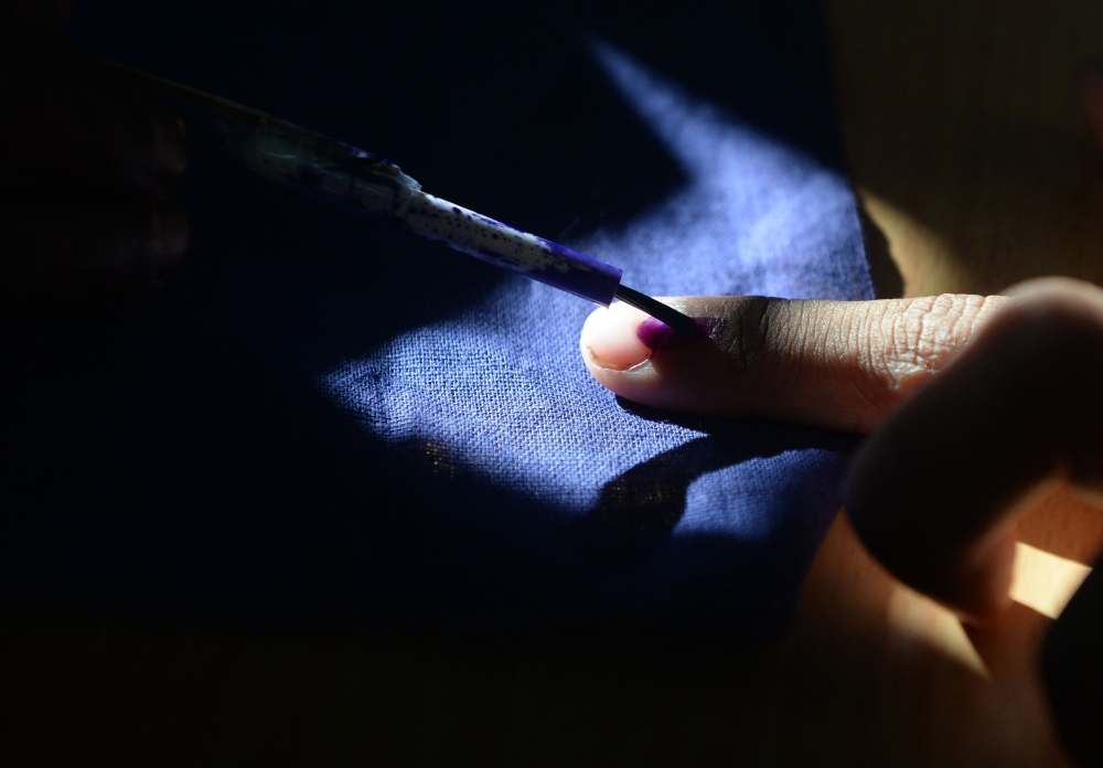 In this file photo taken on April 18, 2019 an Indian voter gets his finger marked with ink as he votes at a polling station in Chennai, during the second phase of the mammoth Indian elections. / AFP / ARUN SANKAR 