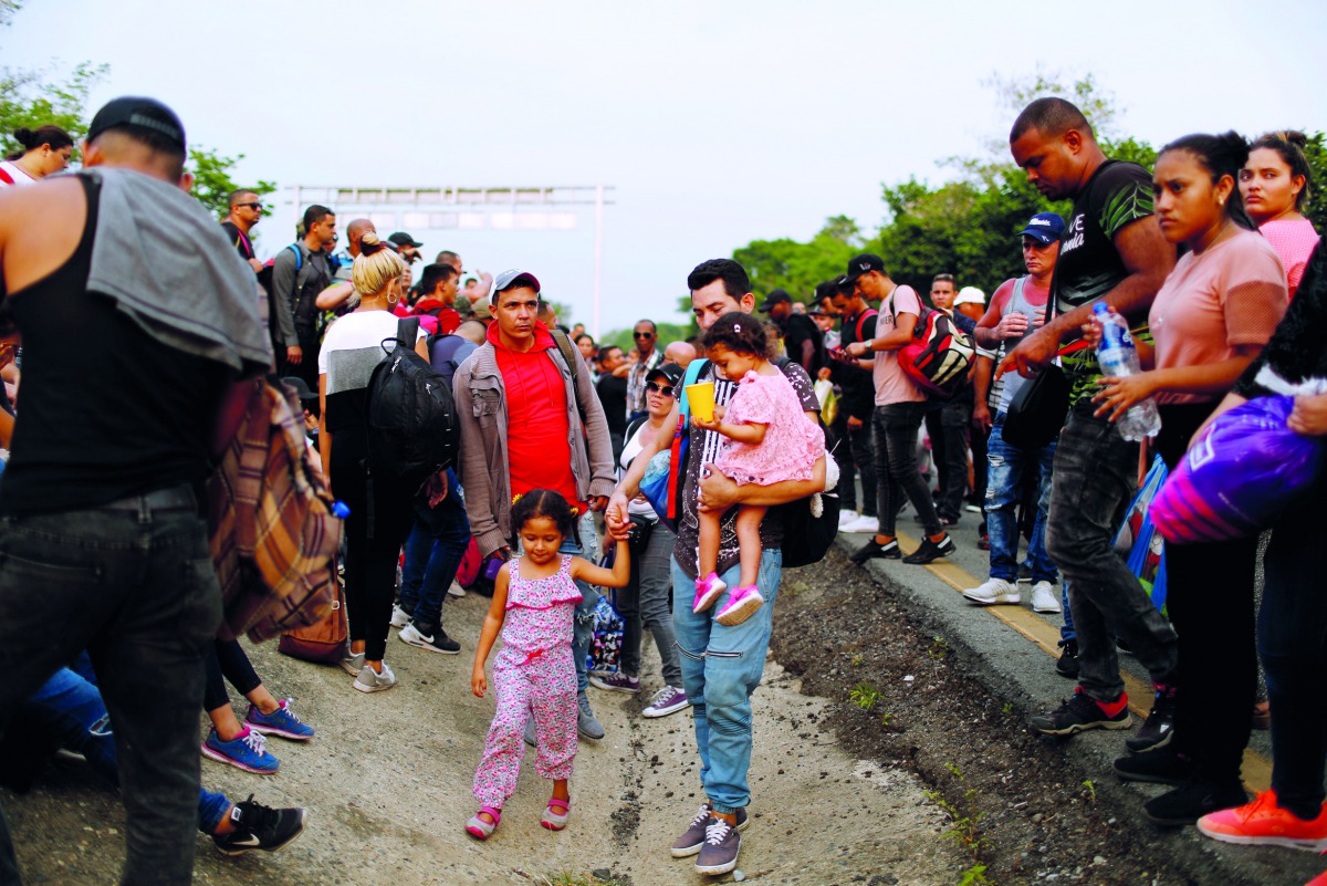 Cuban migrants stand along a road after their buses were seized by Mexican authorities as they participate in the Migrant Via Crucis to continue in their journey towards the United States, in Huixtla, April 17, 2019. Reuters/Jose Cabezas