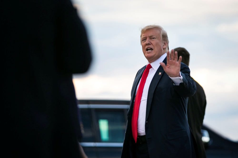 U.S. President Donald Trump waves after arriving aboard Air Force One after spending Easter weekend at his Mar-a-Lago club, at Joint Base Andrews, Maryland, U.S., April 21, 2019. REUTERS/Al Drago