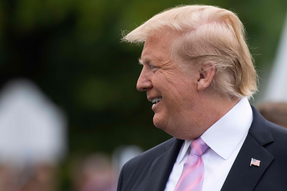 US President Donald Trump smiles during the annual White House Easter Egg Roll on the South Lawn of the White House in Washington, DC on April 22, 2019. / AFP / Jim WATSON