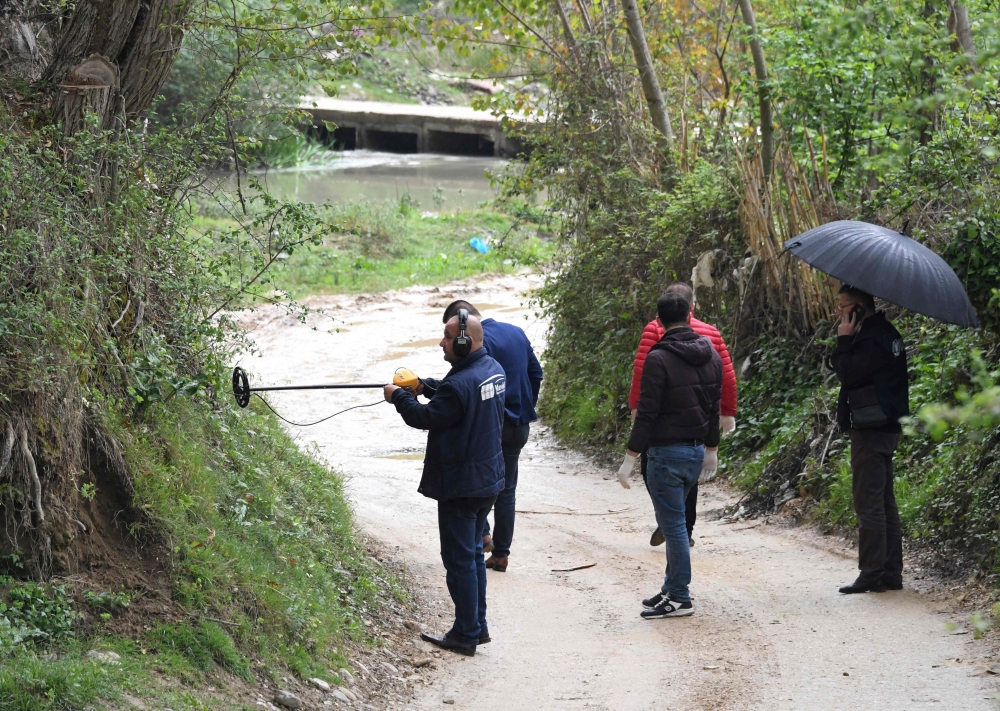 Forensic team search for evidence near the village of Rinas near Tirana on April 10 2019 at the place where police clashed with robbers who stole millions of euros from Austria, Airlines plane. AFP/Gent Shkullaku