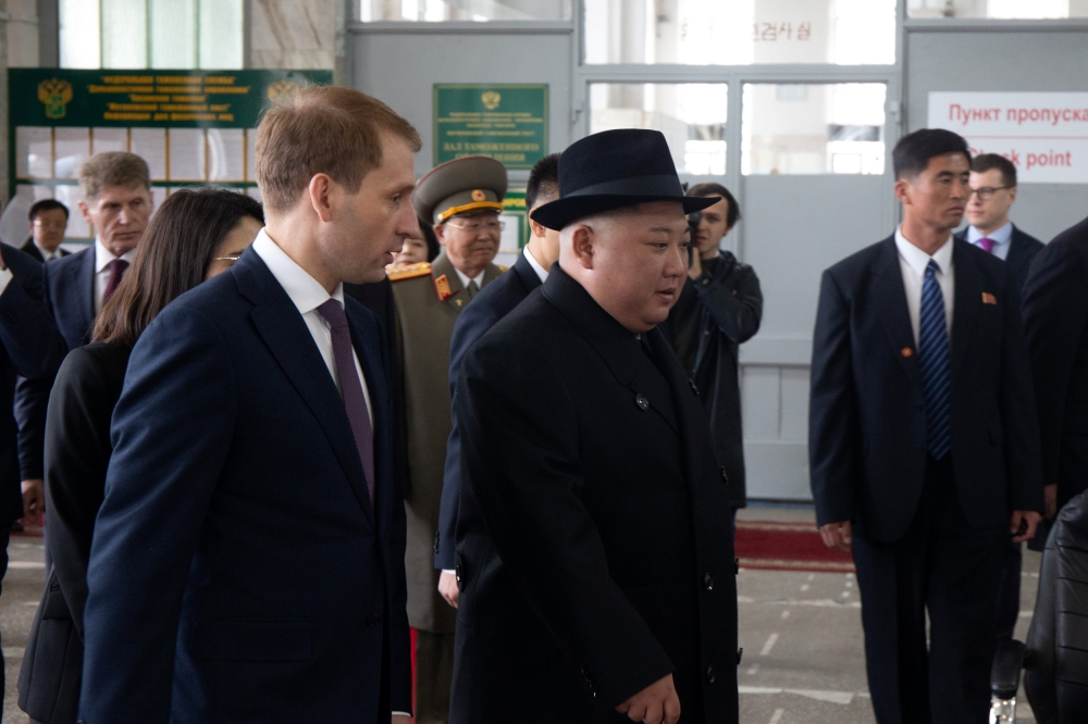 North Korean leader Kim Jong Un (R) attends a meeting with Russia's Minister for the Development of the Russian Far East Alexander Kozlov upon his arrival at a railway station in Khasan, Russia April 24, 2019. 