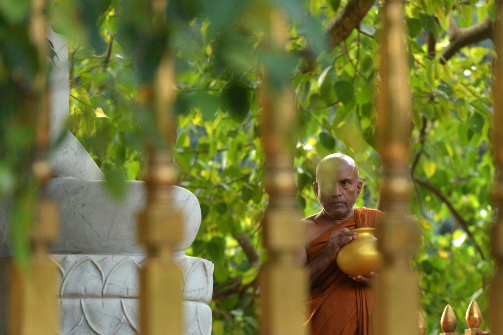 A Buddhist monk prays for the bomb blast victims at Kelaiya temple in Colombo on April 24, 2019, three days after a series of suicide attacks targeting churches and luxury hotels in Sri Lanka. AFP / Ishara S Kodikara 
