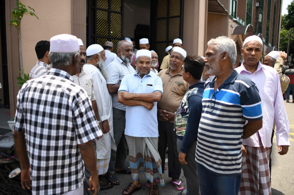 In this photo taken on April 23, 2019, members of the Sri Lanka Muslim community gather outside a mosque after prayers in Colombo. AFP / Mohd Rasfan