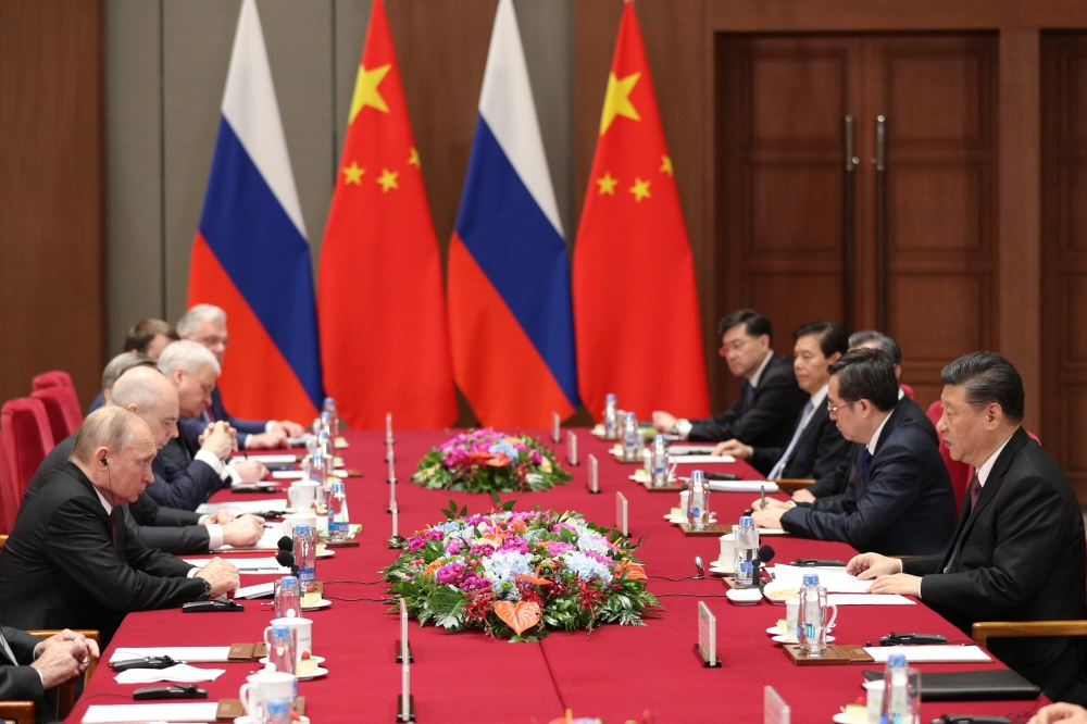 Russian President Vladimir Putin (L) attends a meeting with Chinese President Xi Jinping (R) on the sidelines of the Belt and Road Forum in Beijing on April 26, 2019. / AFP / POOL / Kenzaburo FUKUHARA 