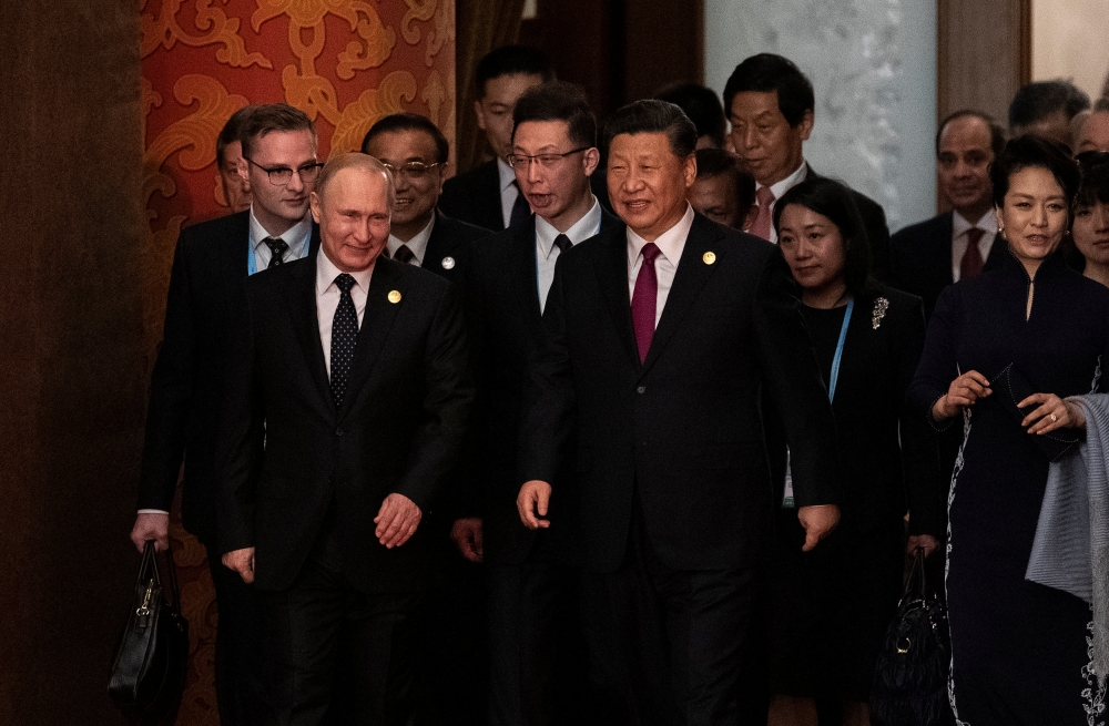 Russian President Vladimir Putin and Chinese President Xi Jinping arrive for a welcoming banquet, after the welcome ceremony of leaders attending the Belt and Road Forum at the Great Hall of the People in Beijing, China April 26, 2019. Nicolas Asfouri/Poo