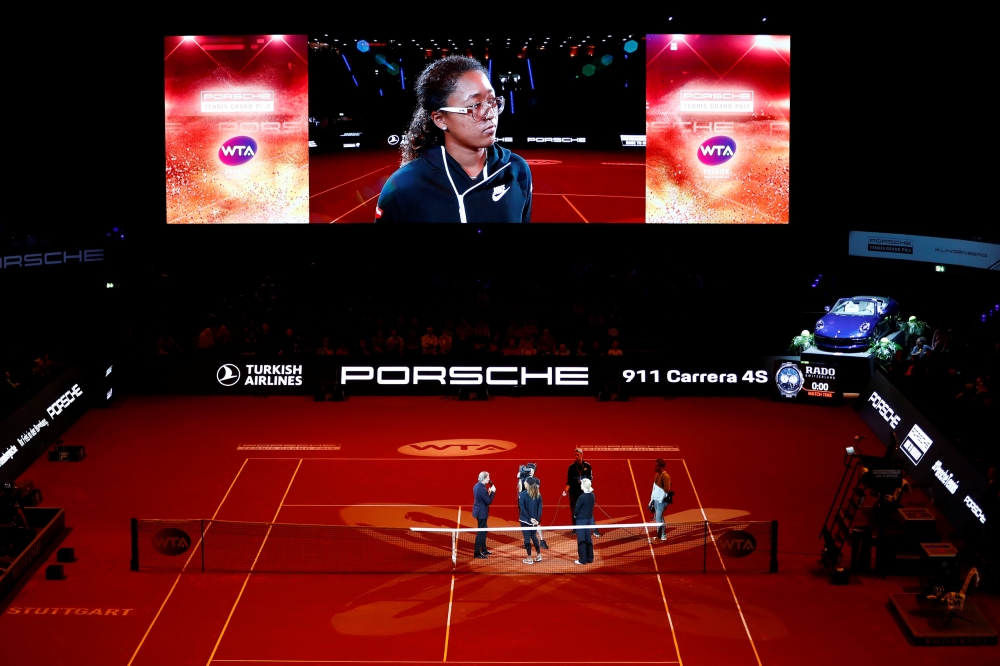 Japan's Naomi Osaka is interviewed on the court after she withdrew from her semi final match against Estonia's Anett Kontaveit due to injury REUTERS/Kai Pfaffenbach