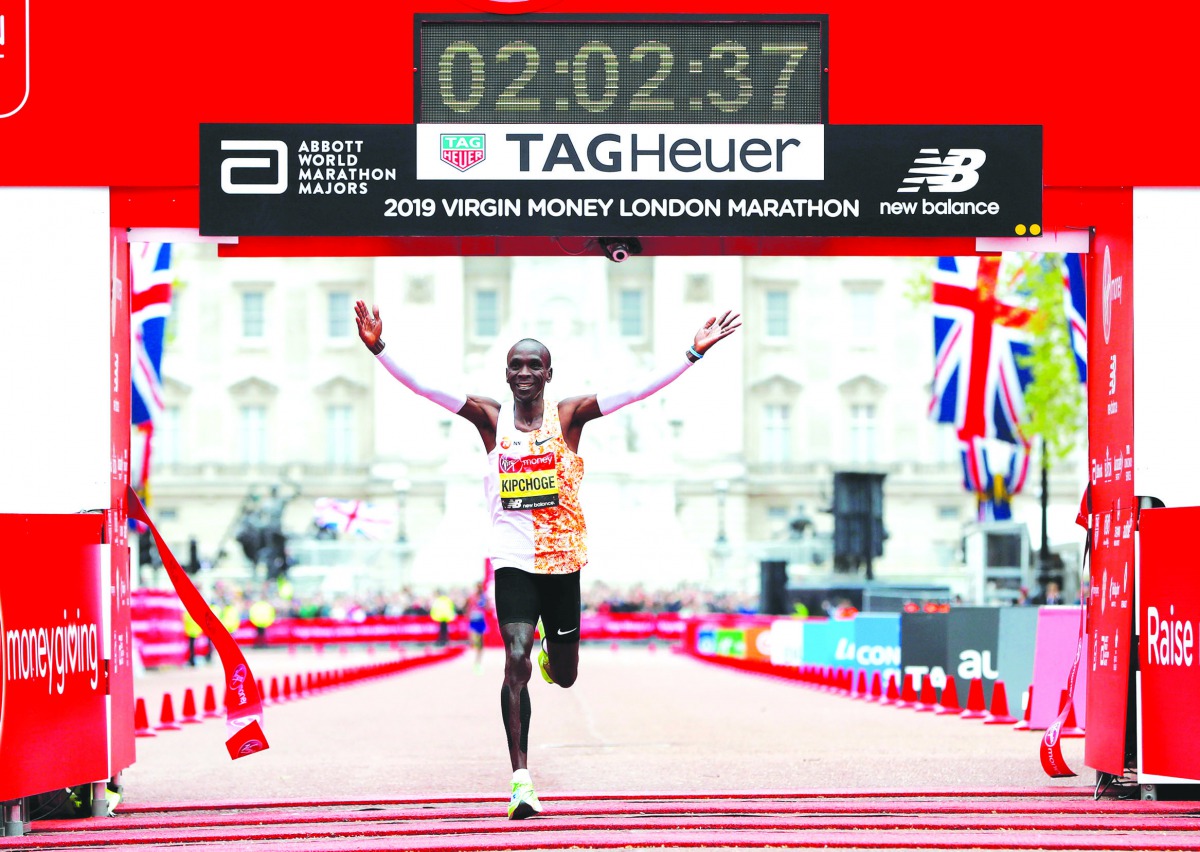 Kenya’s Eliud Kipchoge celebrates as he wins the men’s elite race,  setting a new course record during the London Marathon in London, Britain, yesterday.