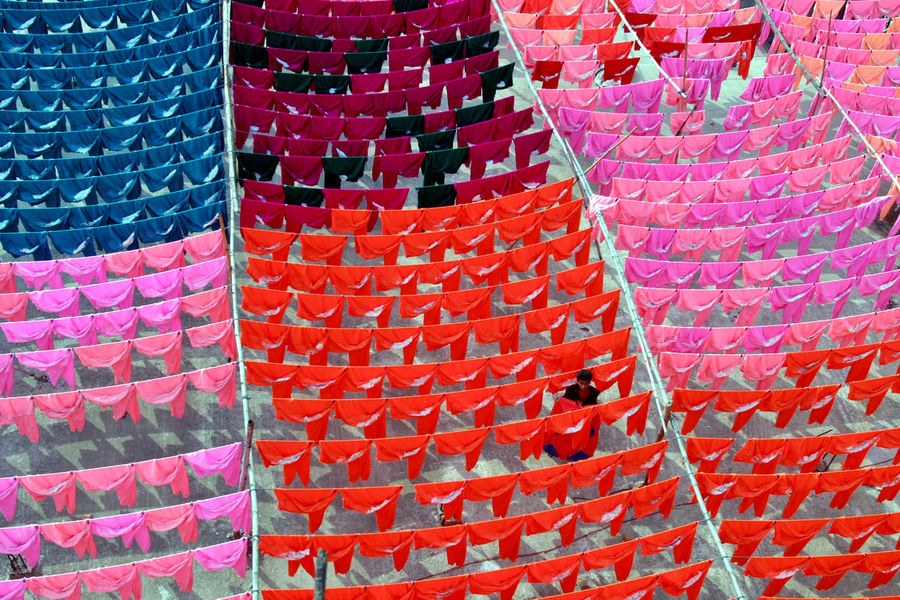 A worker hangs clothes to dry on the roof of a garment factory in Dhaka in this June 15, 2005 file photo. Reuters / Rafiqur Rahman