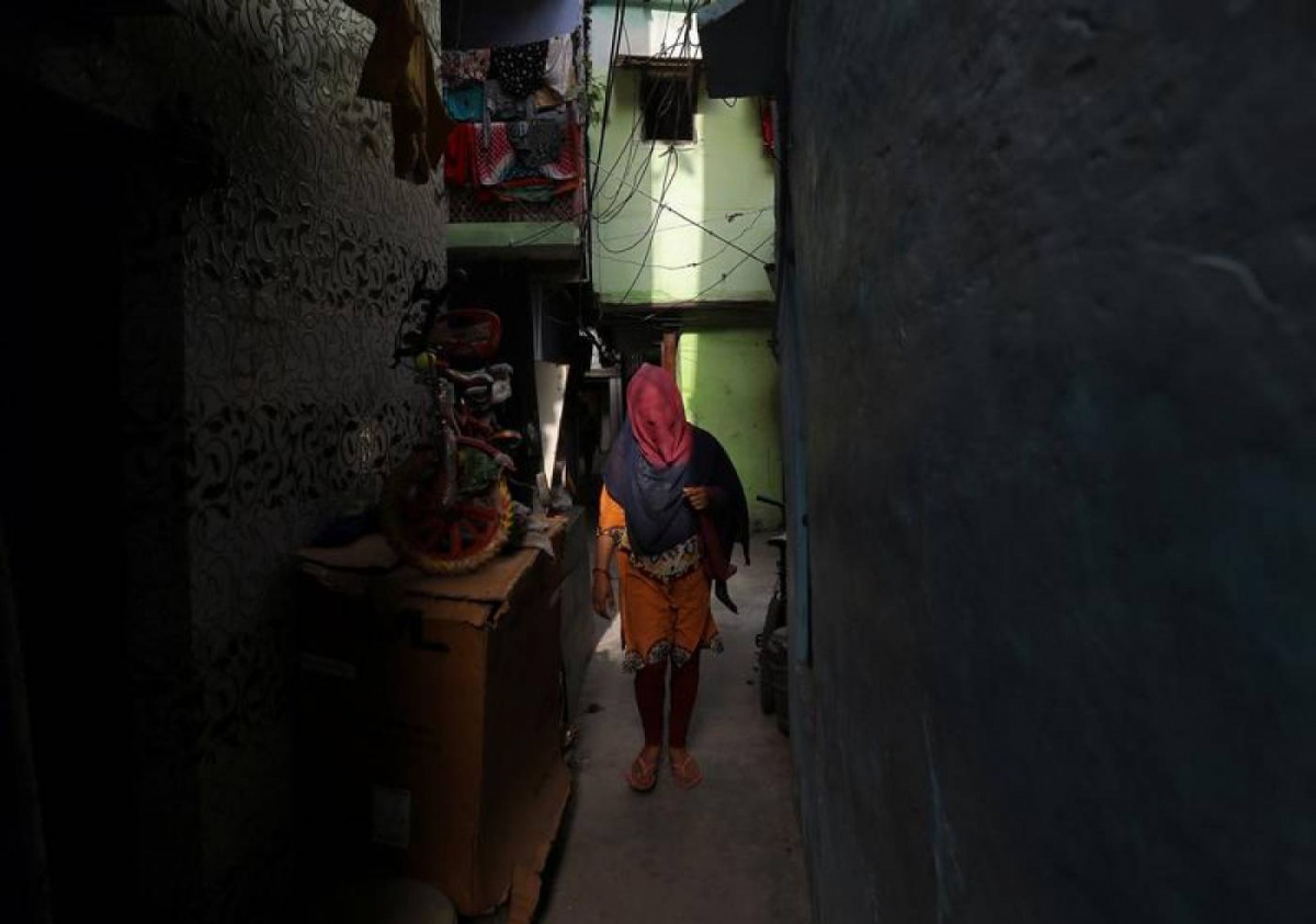A woman walks through an alley in a residential area in New Delhi, India, April 30, 2019. Reuters/Anushree Fadnavis