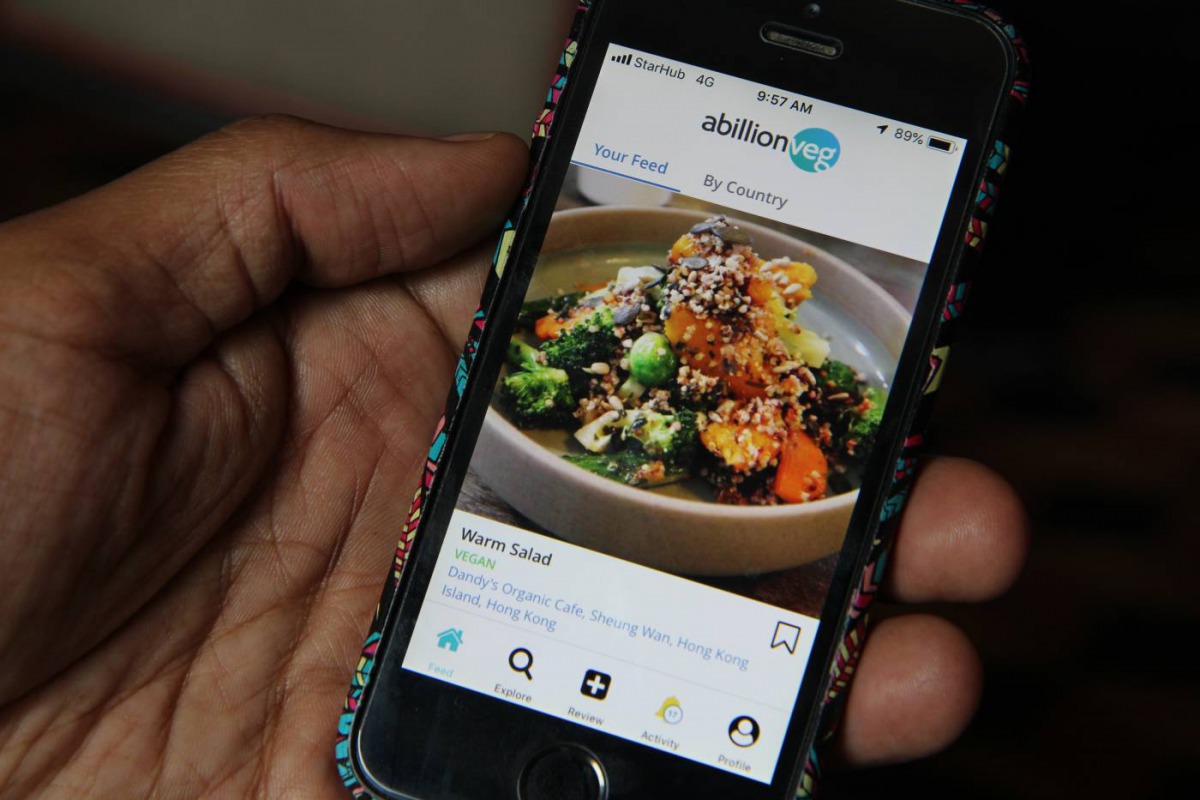 Vikas Garg, founder of abillionveg, shows a mobile phone app that reviews vegetarian and vegan dishes, demonstrating how to use it in Singapore on Feb 12, 2019. Thomson Reuters Foundation/Thin Lei Win 
