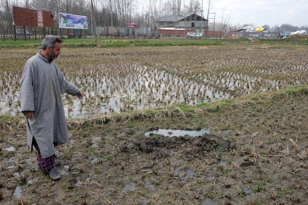Shafqat Ahmad Bhat, a civilian, points to where he says he was forced to bury an unexploded rocket used by the Indian army in a gun battle with suspected militants in Pinglan village in south Kashmir's Pulwama district March 21, 2019.  Reuters 