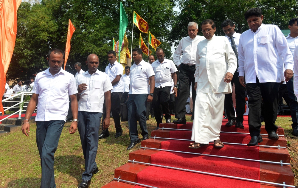 Sri Lanka's President Maithripala Sirisena (C) and Prime Minister Ranil Wickremesinghe (L) arrive for a commemoration ceremony to mark the 26th anniversary of the assassination of Sri Lanka's then-president Ranasinghe Premadasa in Colombo on May 1, 2019. 